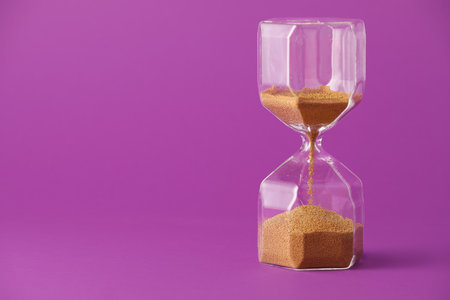 Hourglass on color background. Time management concept