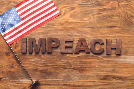 Word IMPEACH and USA flag on wooden backgroundの写真素材