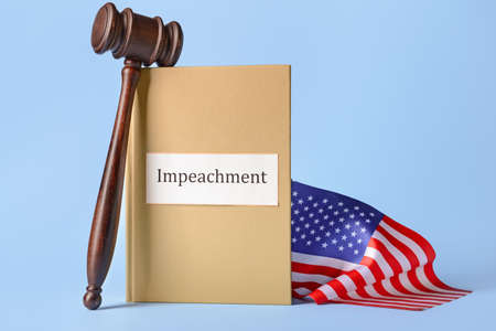 Book with word IMPEACHMENT, USA flag and judge gavel on color background