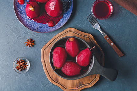 Composition with sweet poached pears in red wine on dark backgroundの写真素材