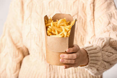 Woman with tasty french fries, closeupの写真素材