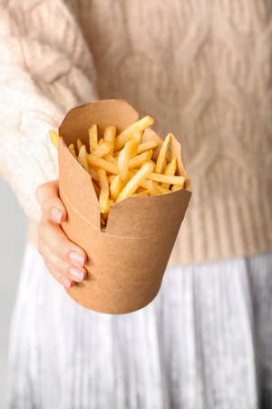Woman with tasty french fries, closeupの写真素材