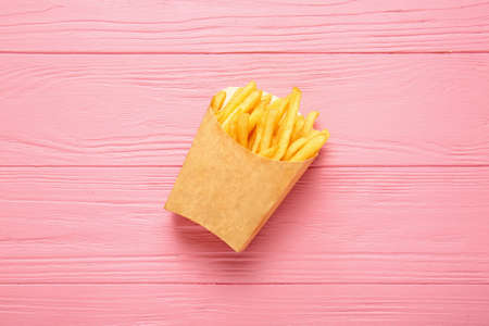 Paper box with tasty french fries on tableの写真素材