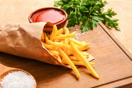 Tasty french fries with tomato sauce on tableの写真素材