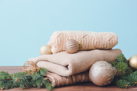 Christmas composition with stylish clothes on table against color backgroundの写真素材