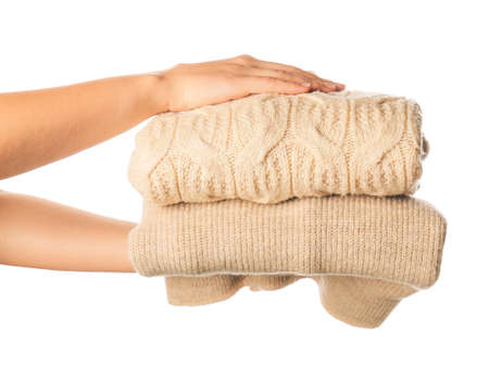 Female hands with warm clothes on white backgroundの写真素材