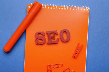 Abbreviation SEO with stationery on color backgroundの写真素材