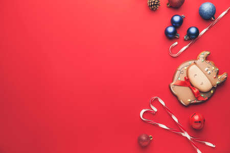 Tasty cookie in shape of bull and Christmas decor on color backgroundの写真素材