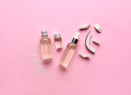 Composition with bottles of coconut oil on color backgroundの写真素材