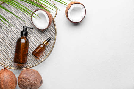 Composition with bottles of coconut oil on light backgroundの写真素材