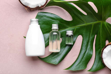 Composition with bottles of coconut oil on color backgroundの写真素材