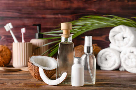 Composition with bottles of coconut oil on wooden backgroundの写真素材