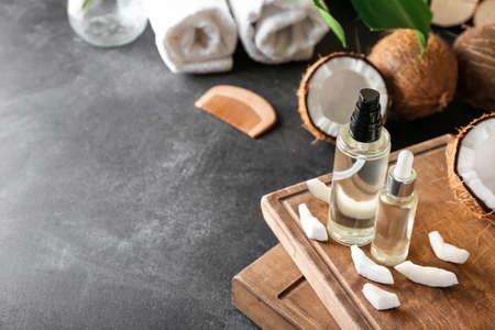 Composition with bottles of coconut oil on dark backgroundの写真素材