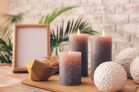 Beautiful aroma candles with decor on tableの写真素材