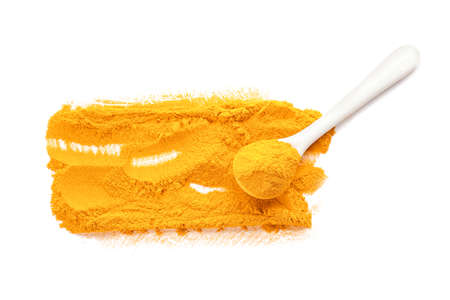Spoon with turmeric powder on white background