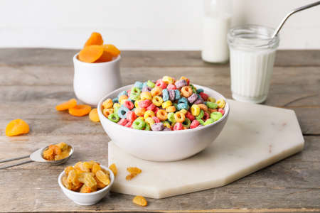 Composition with tasty cereal rings on wooden background