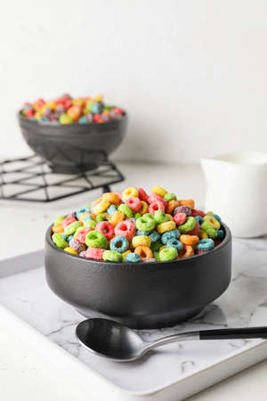 Bowls with tasty cereal rings on light backgroundの写真素材