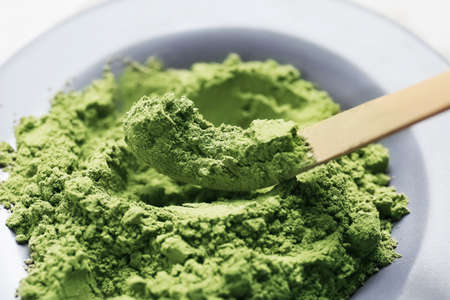 Plate and chashaku with powdered matcha tea, closeup