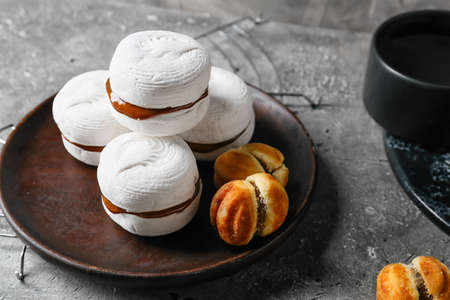 Tasty marshmallows and cookies with boiled condensed milk on grunge backgroundの写真素材