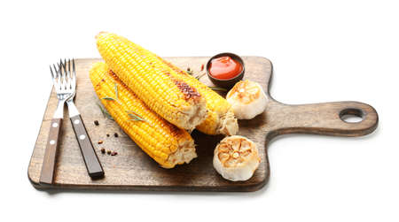 Composition with tasty grilled corn cobs on white backgroundの写真素材