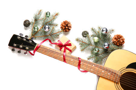 Guitar and Christmas decor on white background