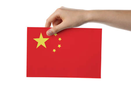 Female hand with paper Chinese flag on white backgroundの写真素材