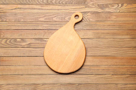 Cutting board on wooden background