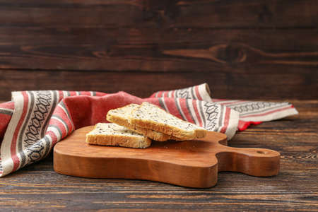 Cutting board and toasts on wooden backgroundの写真素材