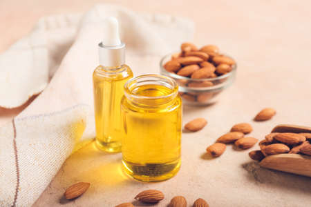 Bottles with almond oil on color background, closeupの写真素材