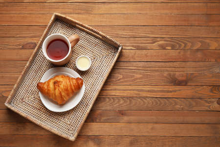 Tray with tasty breakfast on wooden backgroundの写真素材