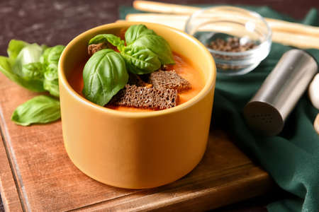 Bowl with tasty tomato cream soup on dark background, closeupの写真素材