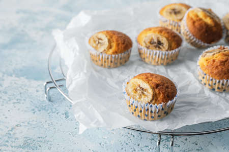 Tasty banana muffins on color backgroundの写真素材