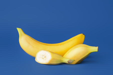 Tasty ripe bananas on color backgroundの写真素材