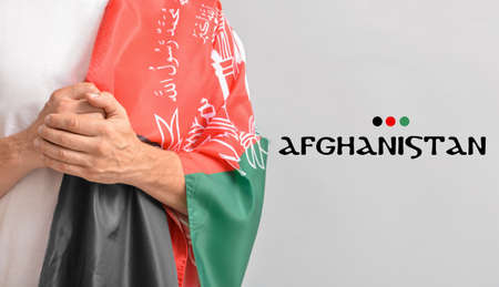 Man with flag and text AFGHANISTAN on gray backgroundの写真素材