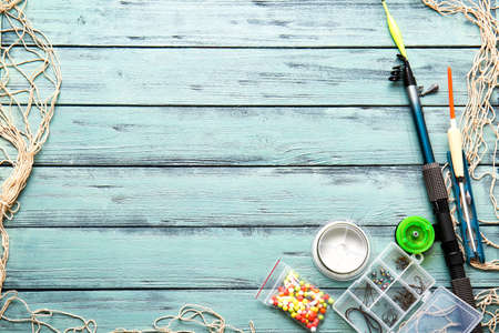 Different fishing equipment on color wooden backgroundの写真素材