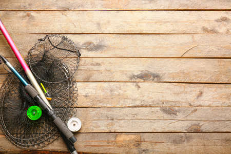 Fishing cage and rods on wooden backgroundの写真素材