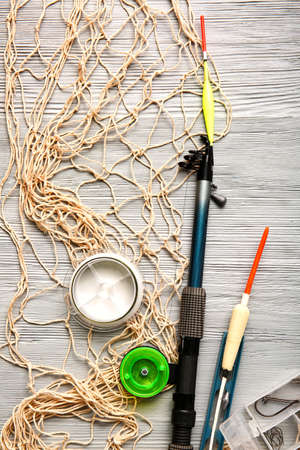 Different fishing equipment on light wooden backgroundの写真素材
