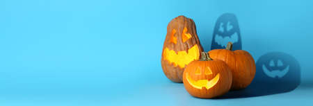 Carved Halloween pumpkins on blue backgroundの写真素材