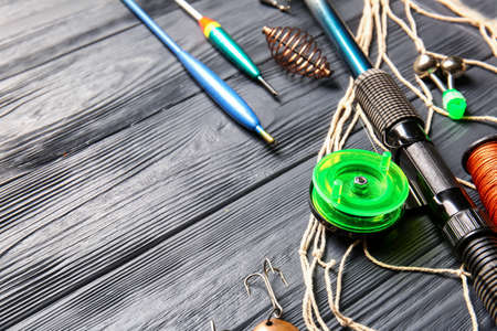 Different fishing equipment on dark wooden backgroundの写真素材