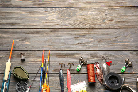 Different fishing equipment on wooden backgroundの写真素材
