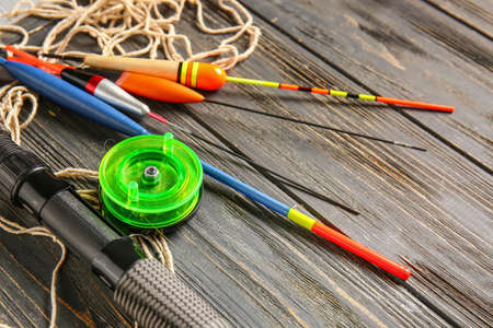 Different fishing equipment on wooden backgroundの写真素材