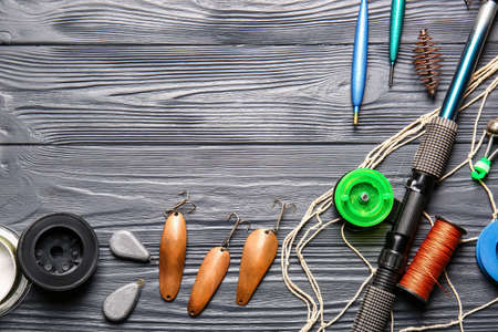 Different fishing equipment on dark wooden backgroundの写真素材