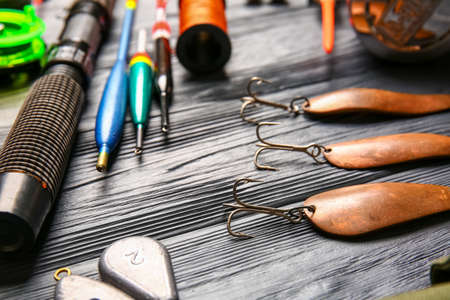 Different fishing equipment on dark wooden background, closeupの写真素材