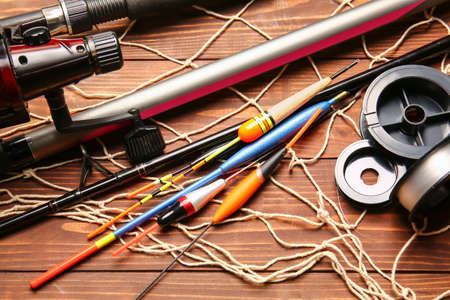 Different fishing equipment on wooden background, closeupの写真素材