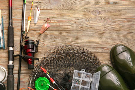 Different fishing equipment on wooden backgroundの写真素材