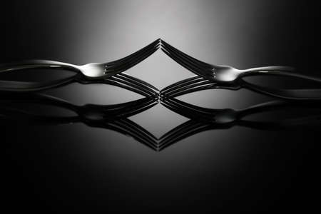 Creative composition with stylish forks on dark backgroundの写真素材
