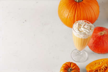 Glass of tasty pumpkin smoothie on white backgroundの写真素材