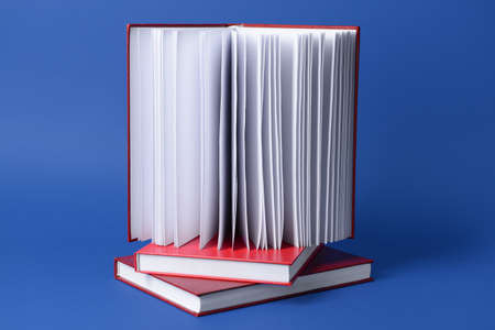 Blank books on color background