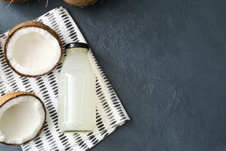 Composition with fresh coconut water on dark background