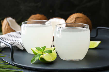 Glasses of fresh coconut water on dark backgroundの写真素材